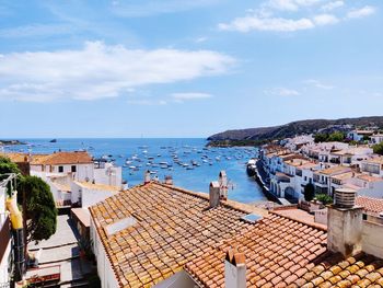 High angle view of townscape by sea against sky