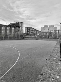 View of soccer field and buildings against sky