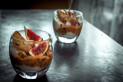 Dessert in drinking glasses on table