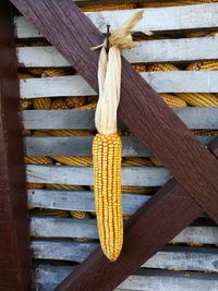 High angle view of banana hanging on wooden table