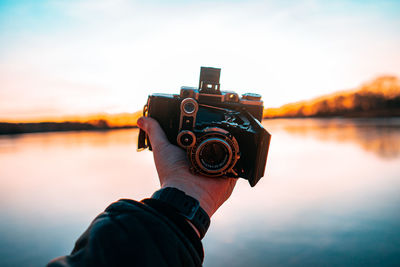 Cropped hand holding vintage camera