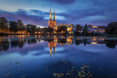 Reflection of buildings in lake against sky