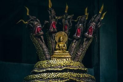 Close-up of statue against illuminated building