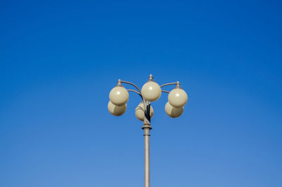 Low angle view of lamp against clear blue sky