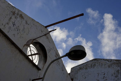 Low angle view of old building against cloudy sky