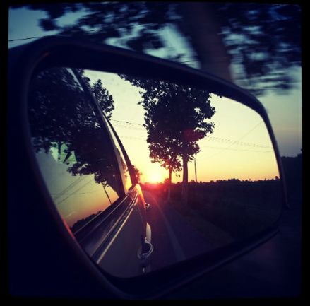 transportation, land vehicle, mode of transport, car, side-view mirror, reflection, sunset, car interior, road, tree, vehicle interior, travel, transparent, glass - material, sky, sun, part of, windshield, on the move, silhouette