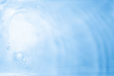 Close-up of water splashing against blue sky