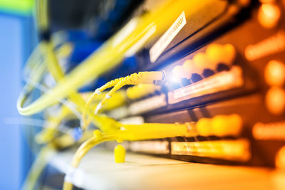 Close-up of yellow cables attached to electrical equipment