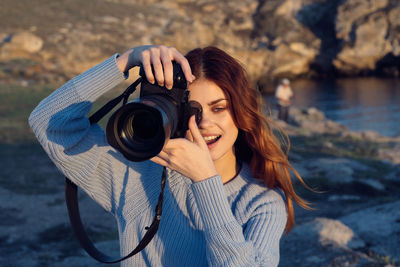 Portrait of woman photographing