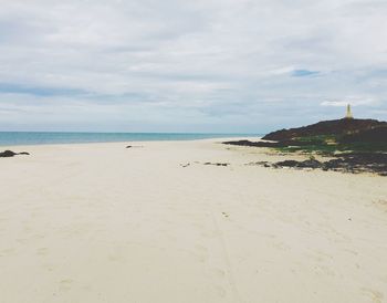 Scenic view of sea against cloudy sky