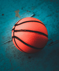 Close-up of red ball on table against wall