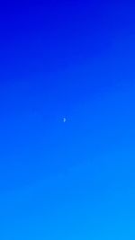 Scenic view of moon in blue sky