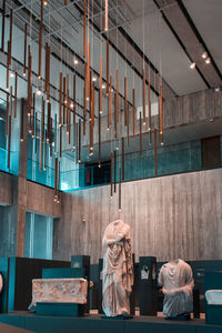 Rear view of woman with umbrella in store