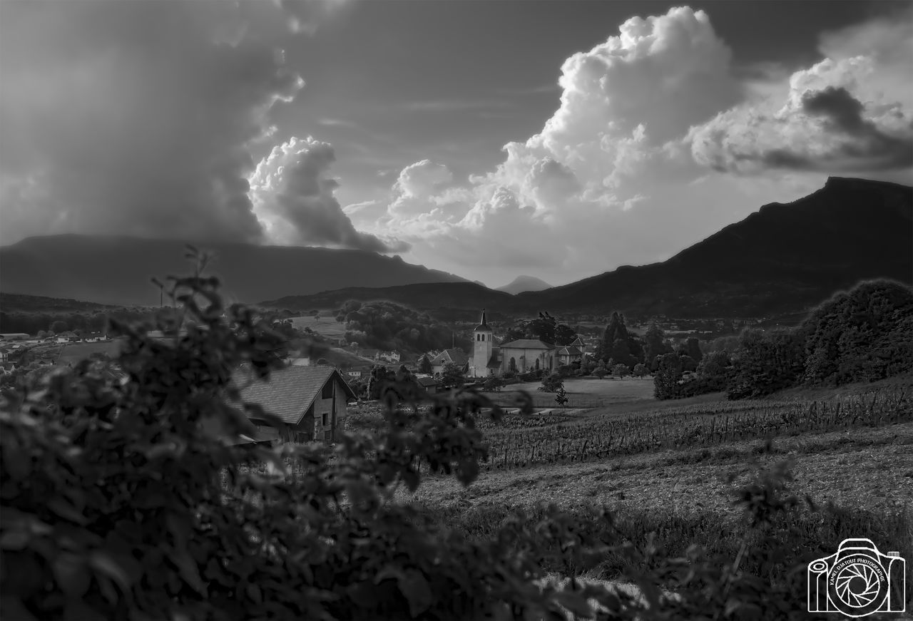 cloud - sky, sky, beauty in nature, land, environment, scenics - nature, plant, field, nature, mountain, landscape, architecture, no people, built structure, building, tranquil scene, tranquility, rural scene, building exterior, day, outdoors