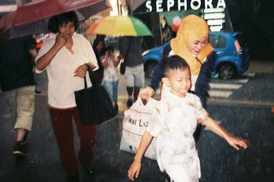 Group of people walking in rain