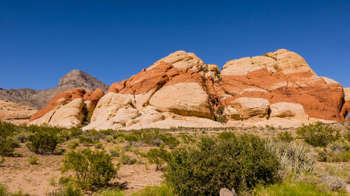 Scenic view of rocky mountains against clear blue sky