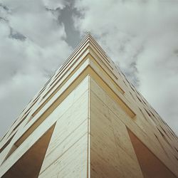 Low angle view of building against cloudy sky