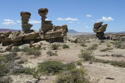 Rock formations on landscape against sky