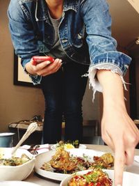 Midsection of woman eating food