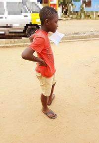 Full length of cute boy standing on beach