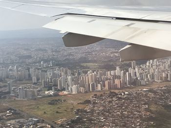 Airplane flying over buildings in city