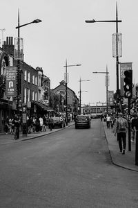People on street in city against clear sky