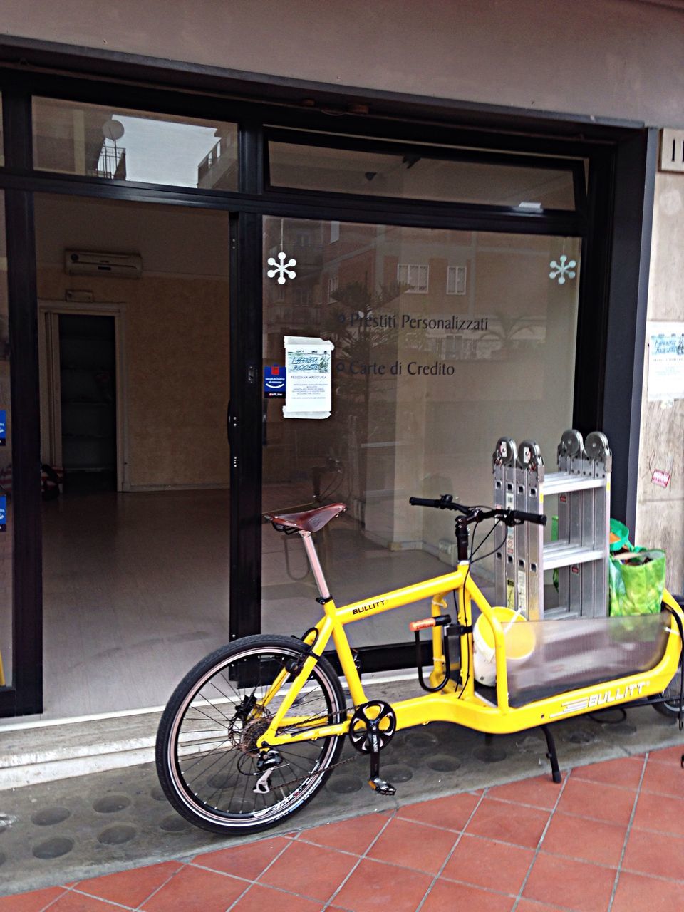 bicycle, transportation, mode of transport, land vehicle, stationary, parked, parking, architecture, built structure, building exterior, wall - building feature, street, travel, cycle, yellow, no people, day, wall, sidewalk, door