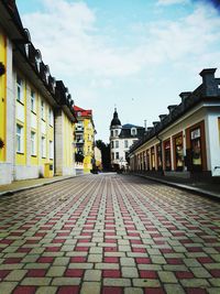 Street amidst buildings in city against sky