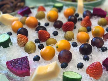 High angle view of colorful fruits on crushed ice