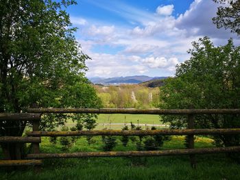 Scenic view of field and mountains against sky