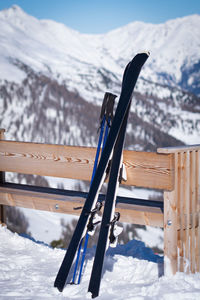 Ski on snow covered field against mountain