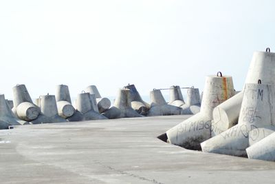 Row of umbrellas on land against clear sky