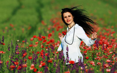 Portrait of smiling young woman standing outdoors