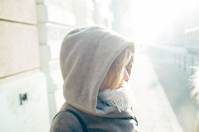 Side view of woman wearing hood