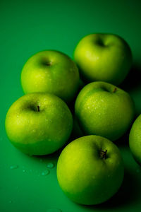 High angle view of apples on green background