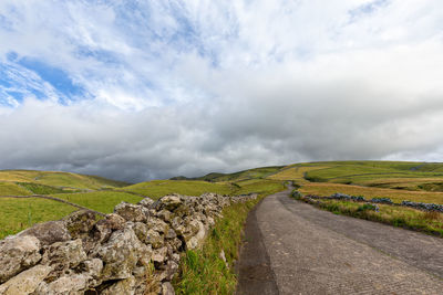 Empty road along countryside landscape