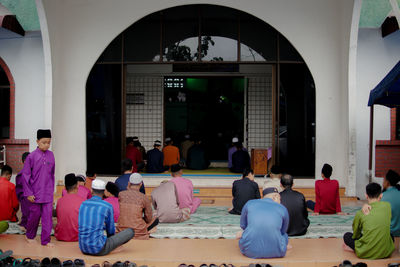 People sitting outside building