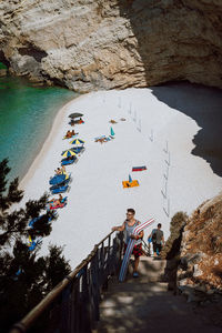 High angle view of people on rock by sea