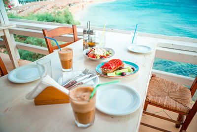 High angle view of breakfast on table at swimming pool