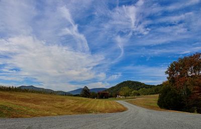 Empty road along countryside landscape