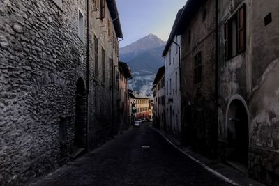 Narrow street amidst buildings against sky