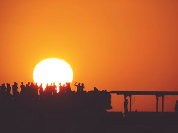 Silhouette of people at sunset