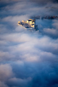 Fortress hohensalzburg rising above a sea of clouds, salzburg, austria