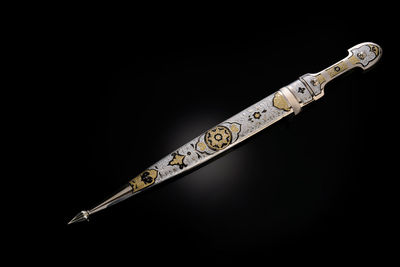 Close-up of thermometer against black background