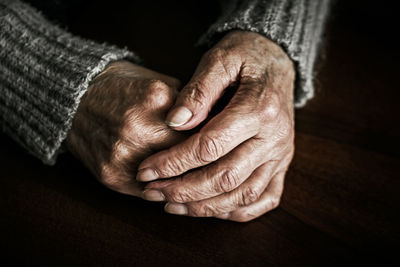 Close up of senior woman hands on table
