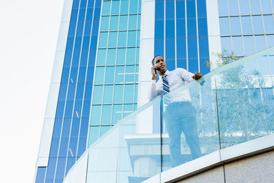 Low angle view of woman standing in city