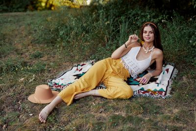 Young woman sitting on field