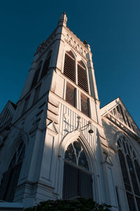 Low angle view of building against clear blue sky
