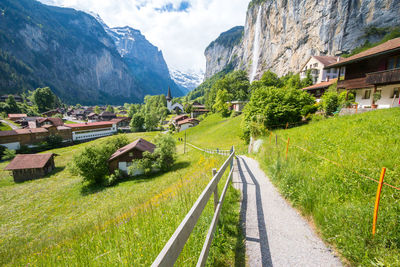 Panoramic shot of road amidst buildings against sky