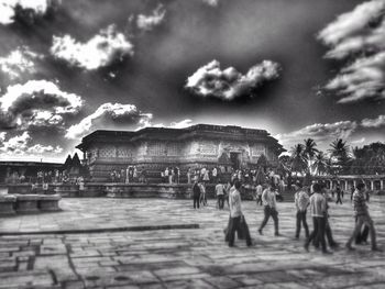 Silhouette of people against cloudy sky